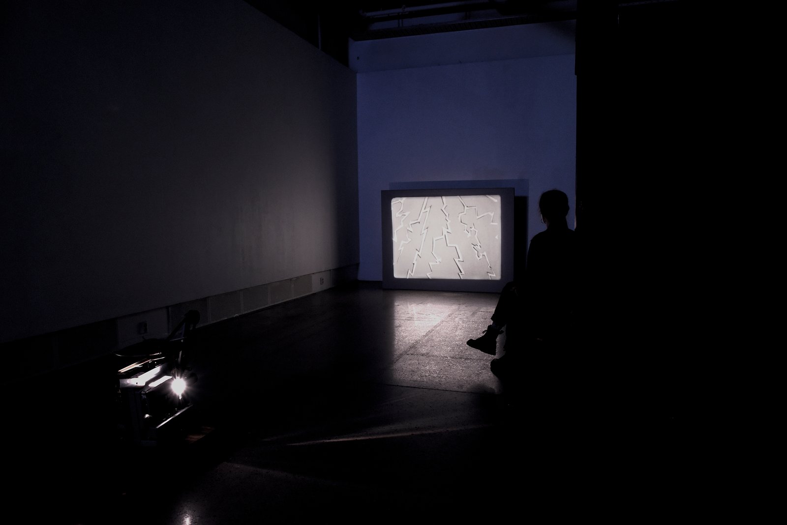 lightning animation in 16mm film installation view with seating by artist Anna Clawson